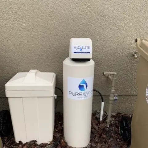 Water softener and H2O Elite system installed against a home exterior
