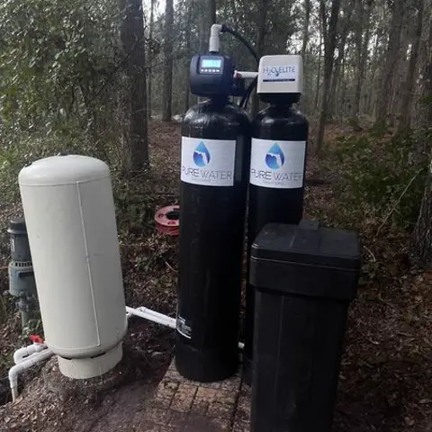 Twin-tank whole-home water filtration system installed outdoors