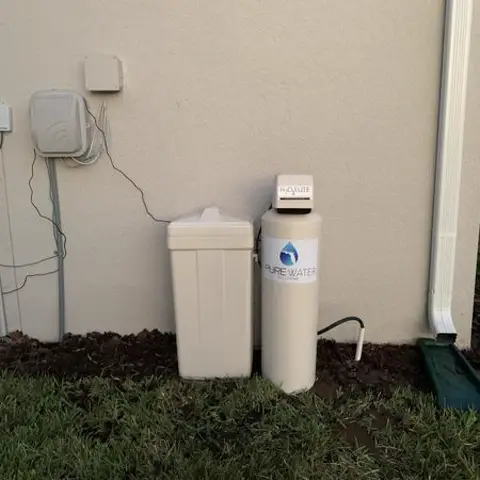 Water treatment system mounted on a garage wall