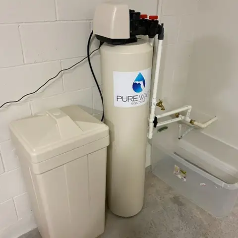 Whole-home water softener installed indoors